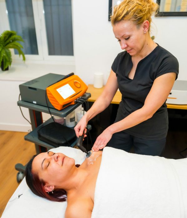 Patient lying on massage table receiving indiba treatment